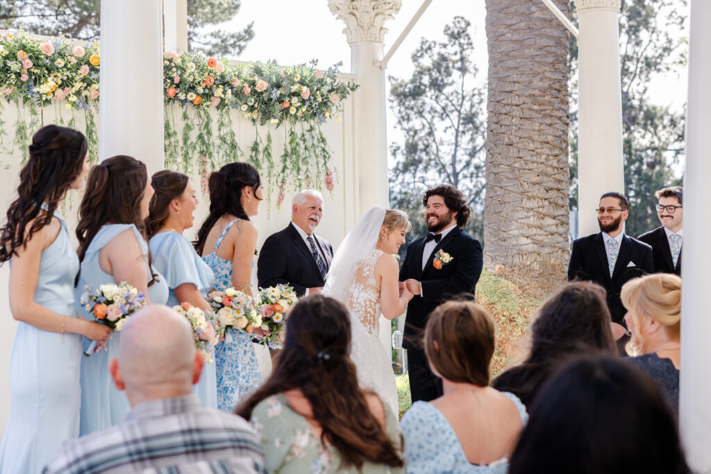 bride and groom laugh during wedding ceremony at jefferson street mansion captured by sacramento wedding photographer