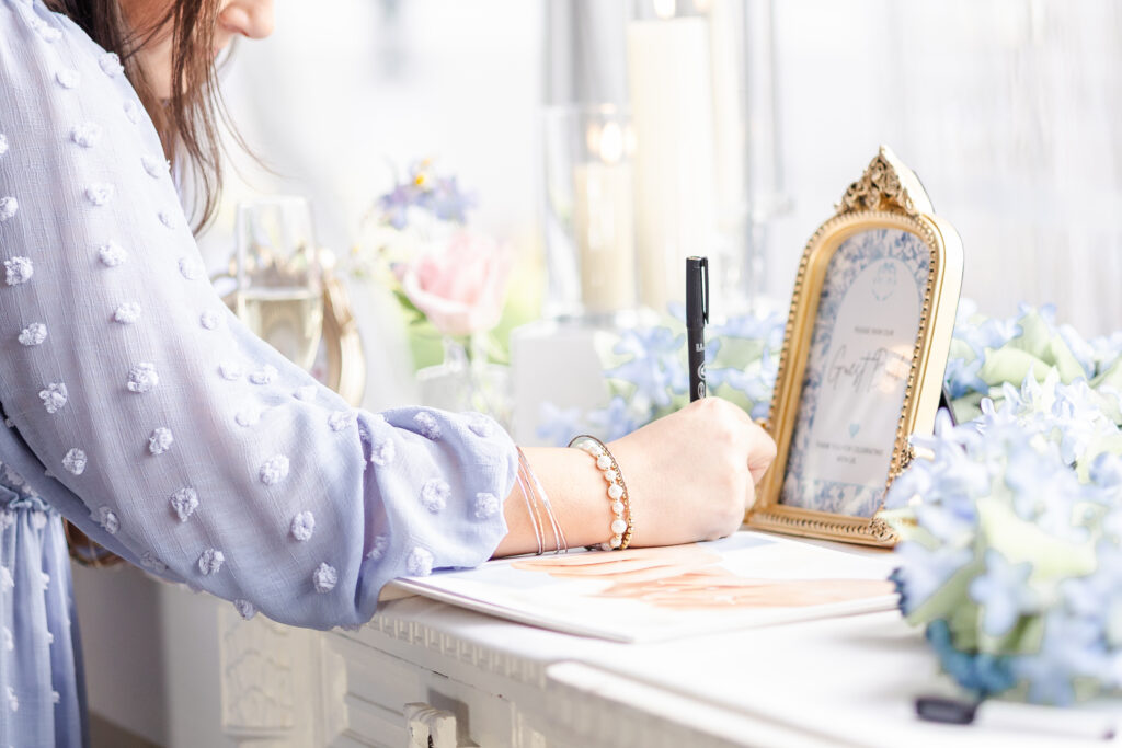 guest signing guest book at jefferson street mansion captured by sacramento wedding photographer