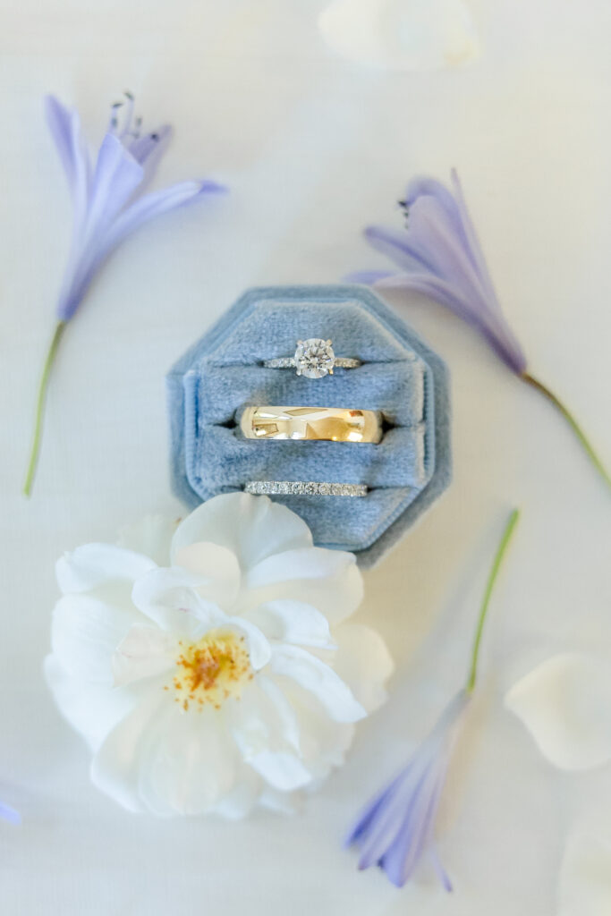 Wedding rings and wildflowers at Park Winters in Winters, California captured by a sacramento wedding photographer