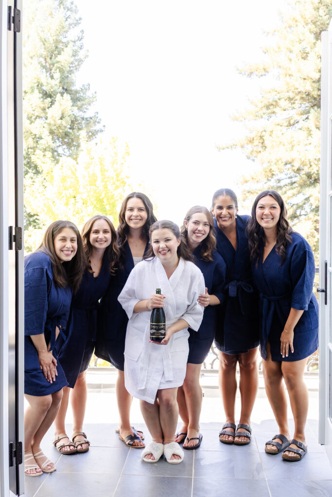 bride and bridesmaids prepare to enjoy champange at Park Winters in Winters, California captured by a sacramento wedding photographer