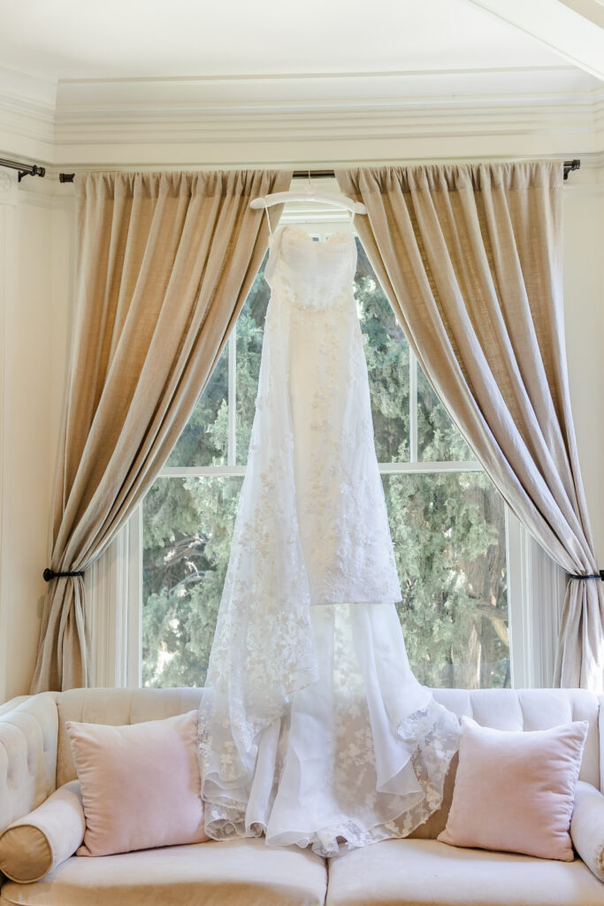 Wedding dress hanging in window at Park Winters in Winters, California captured by a sacramento wedding photographer