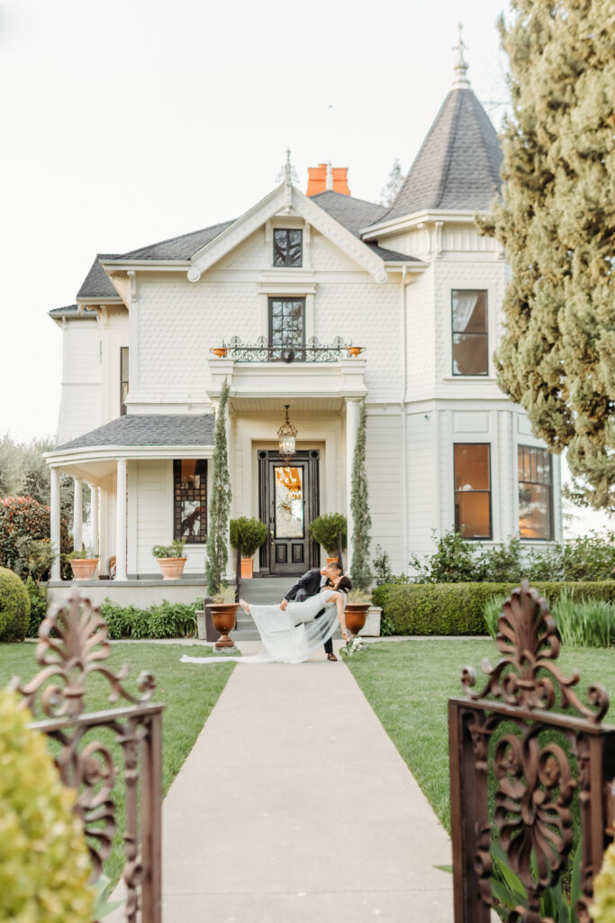 Bride and Groom kiss in front of the iconic estate at Park Winters Wedding captured by Sacramento Wedding Photographer
