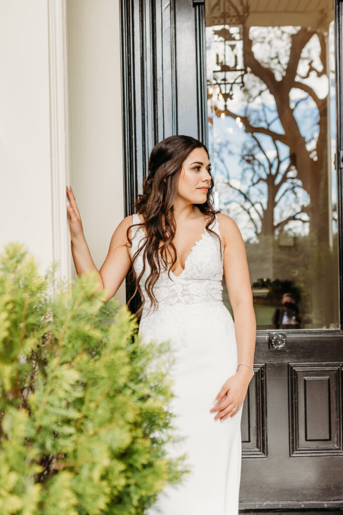 Bride poses in front of the grand door of the estate at Park Winters Wedding captured by Sacramento Wedding Photographer