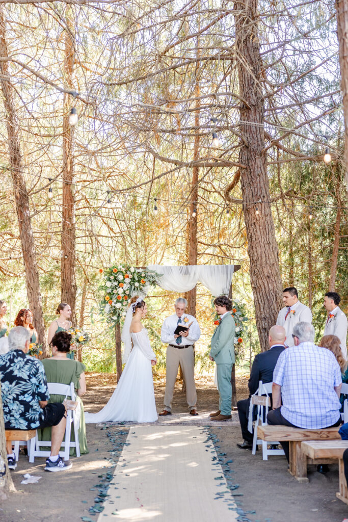 Bride and groom during ceremony of wedding at The Timbers captured by Sacramento Wedding Photographer