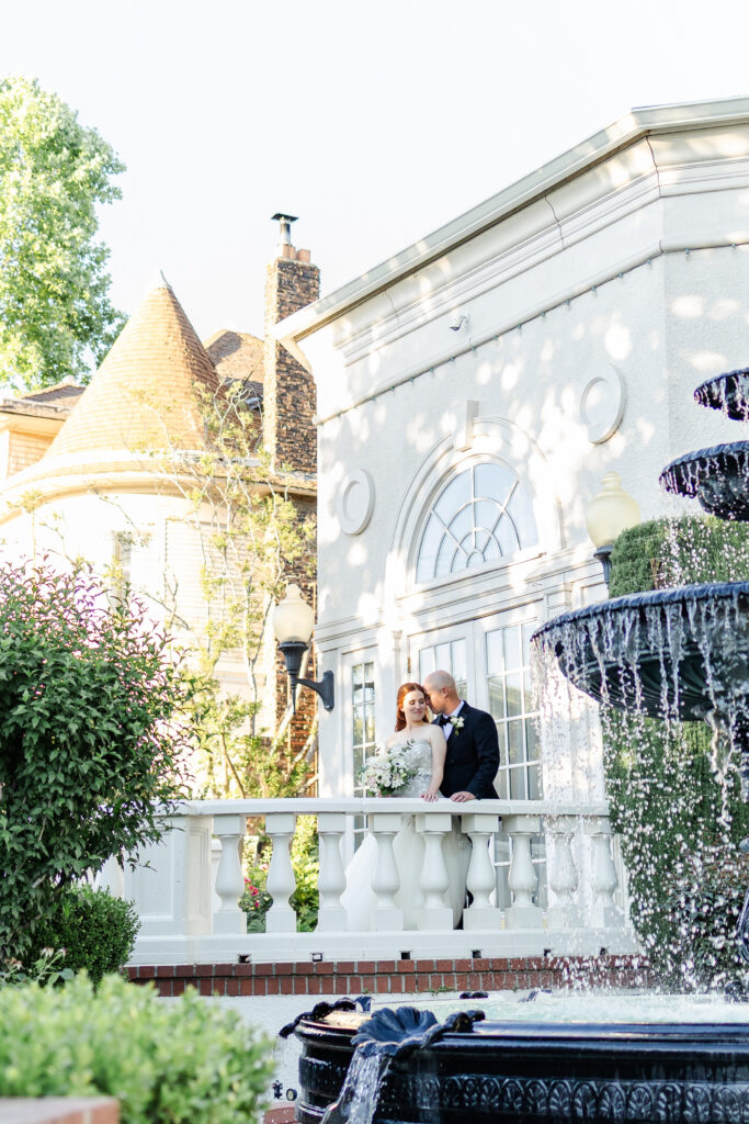 Bride and groom pose by fountain at vizcaya wedding venue captured by a sacramento wedding photographer