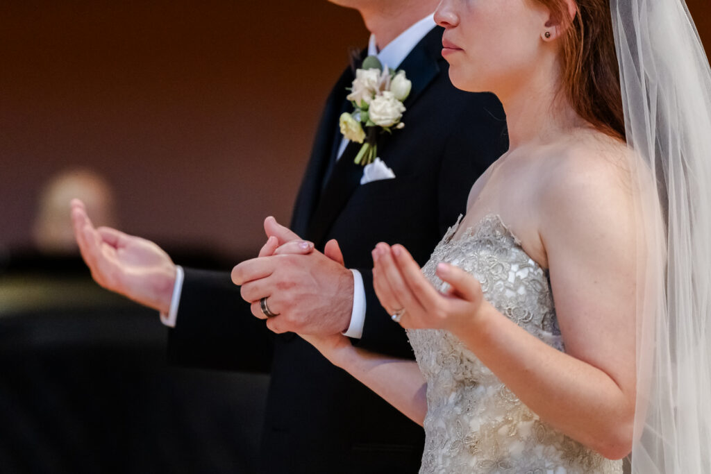 bride and groom pray at church ceremony captured by a sacramento wedding photographer
