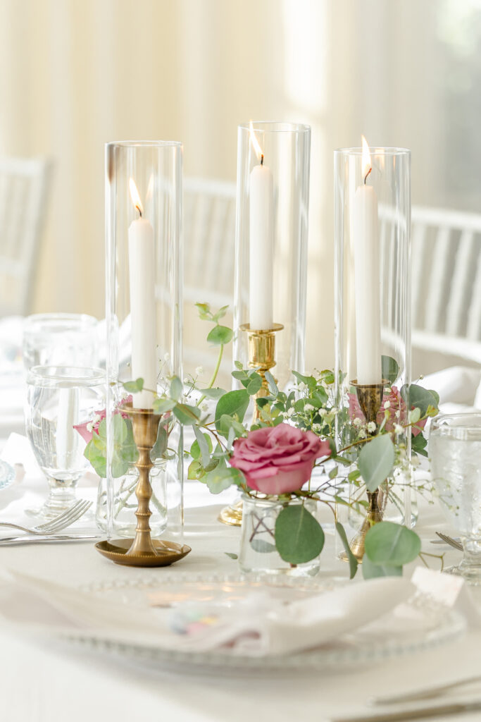  Gold candles with elegant crystal vases feature as the centerpiece at vizcaya wedding venue captured by a sacramento wedding photographer