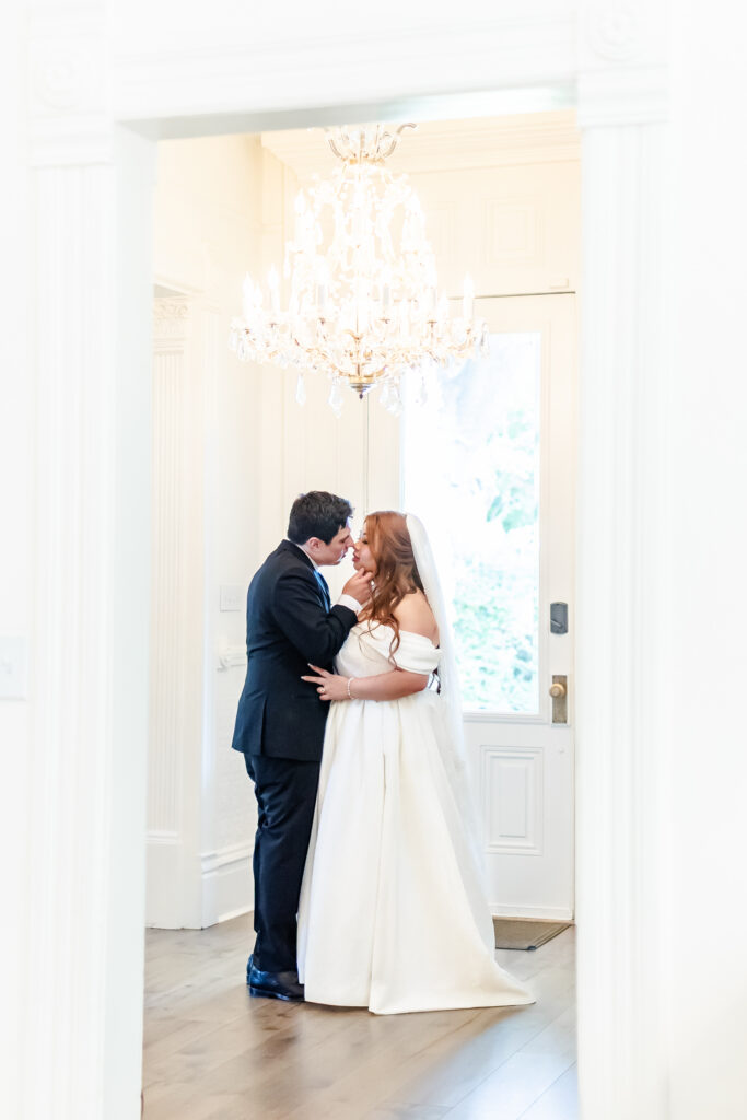 Couple poses for a portrait inside white victorian mansion at Park Winters Wedding Captured by a Sacramento Wedding Photographer