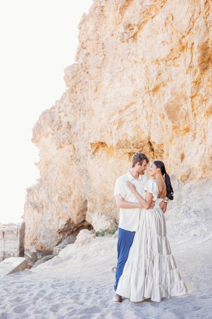 Couple dances on the beach in San Francisco during their engagement session from a sacramento wedding photographer